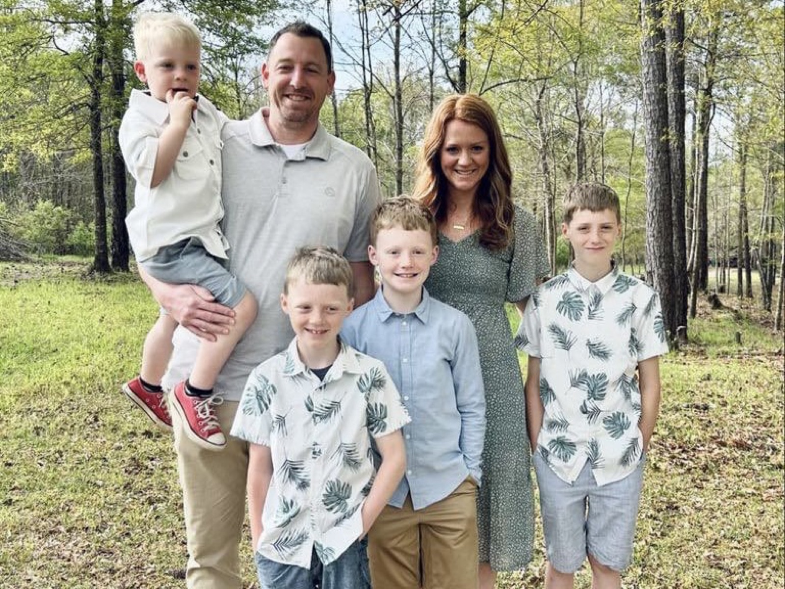 Wesley and family in front of a tractor